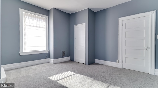 unfurnished bedroom featuring visible vents, baseboards, and carpet floors