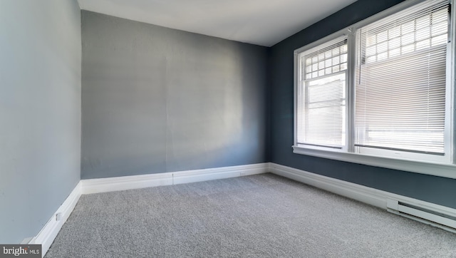 unfurnished room featuring carpet and baseboards