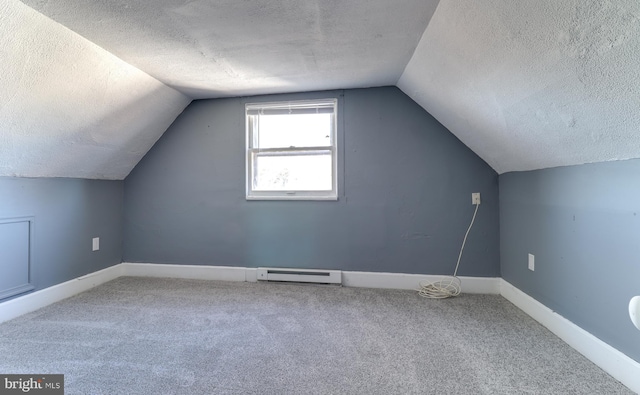 bonus room featuring baseboards, vaulted ceiling, a textured ceiling, a baseboard heating unit, and carpet flooring