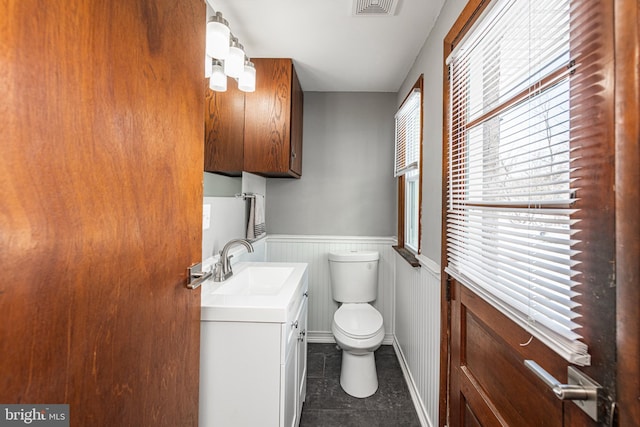 bathroom featuring vanity and toilet