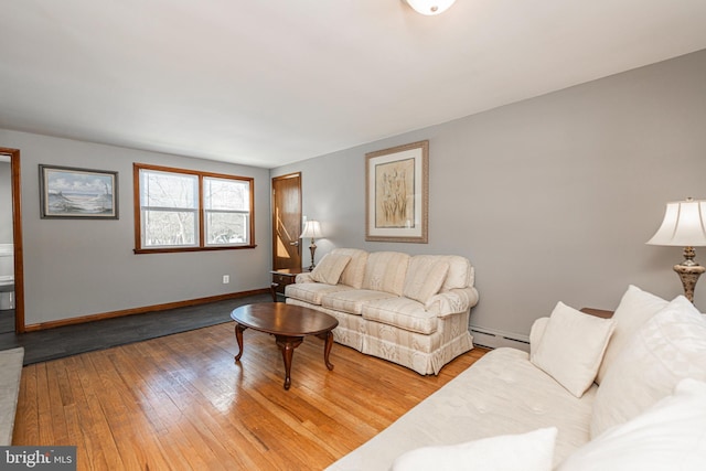 living room with hardwood / wood-style flooring and a baseboard heating unit