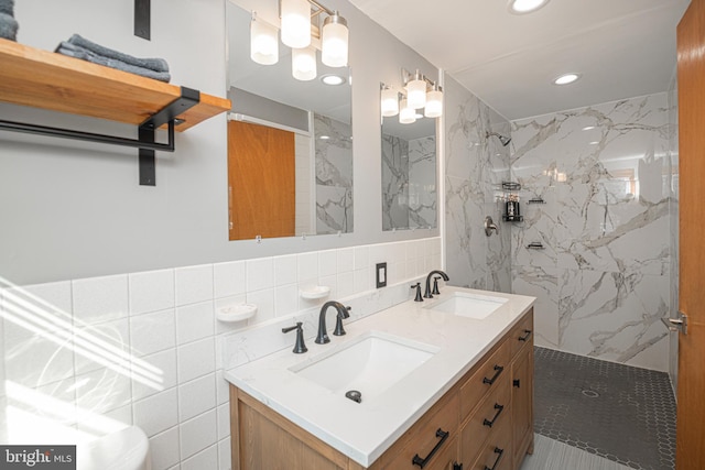 bathroom featuring vanity, tiled shower, tile walls, and backsplash