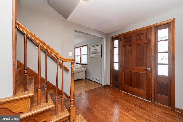 foyer entrance featuring a baseboard radiator and wood-type flooring