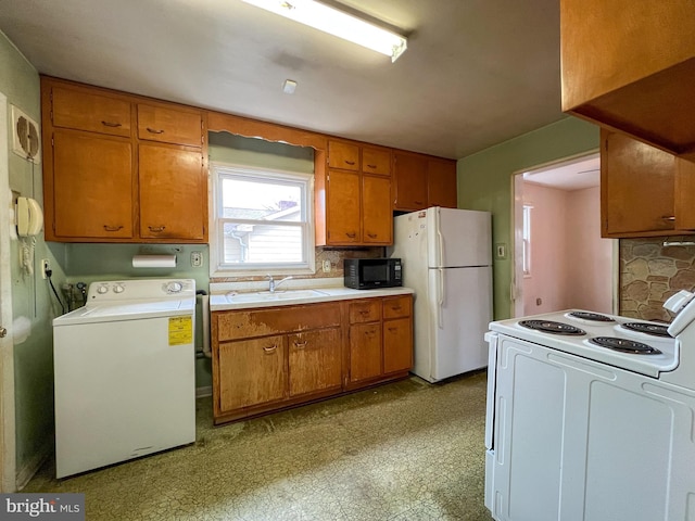 kitchen with washer / dryer, sink, backsplash, and white appliances