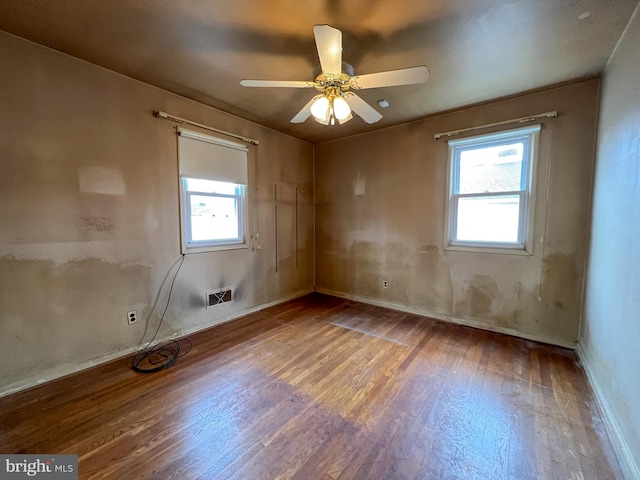 empty room with ceiling fan and wood-type flooring