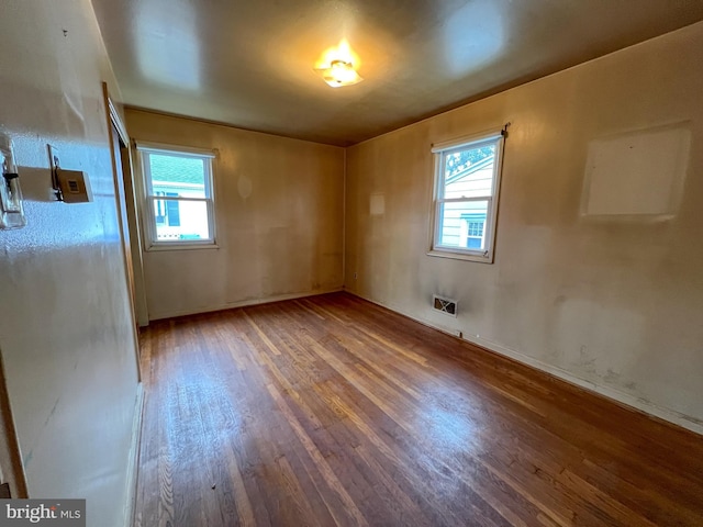 unfurnished room featuring hardwood / wood-style flooring