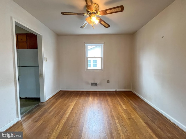 unfurnished room with ceiling fan and wood-type flooring