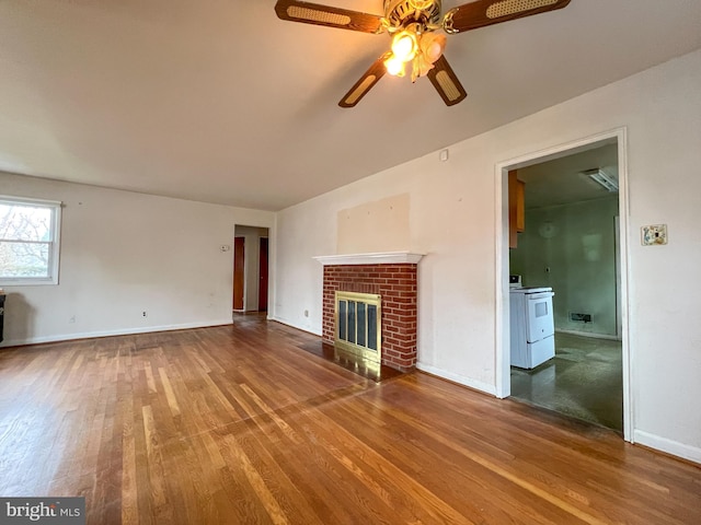 unfurnished living room with a brick fireplace, hardwood / wood-style floors, and ceiling fan