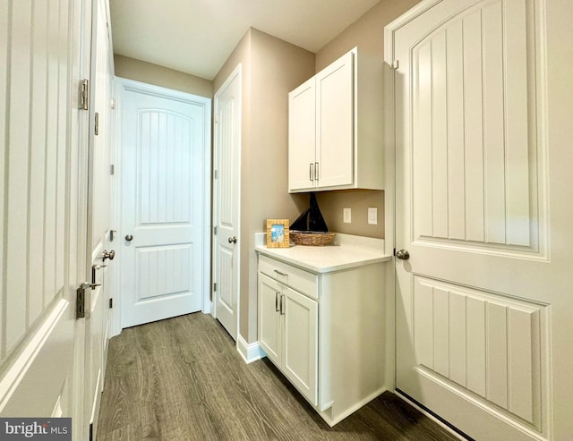 interior space with hardwood / wood-style floors and white cabinets