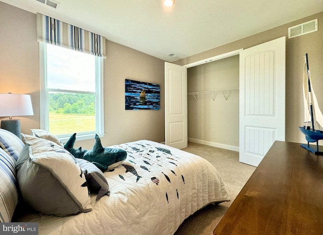 bedroom featuring light colored carpet and a closet