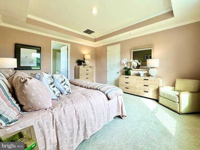 bedroom featuring a tray ceiling, ornamental molding, and carpet flooring