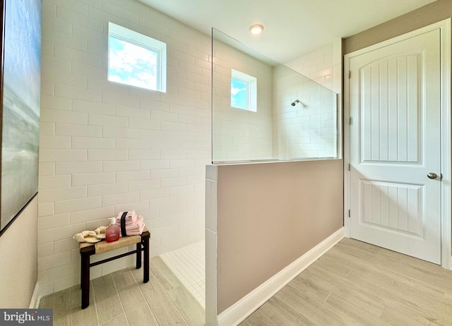 bathroom featuring hardwood / wood-style floors and tiled shower