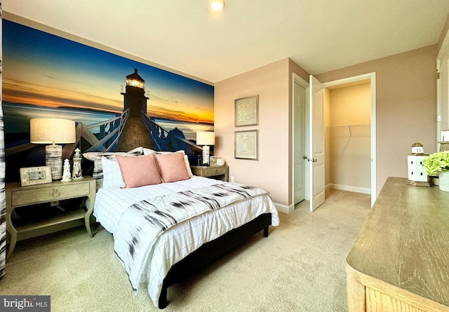 bedroom with a closet, a spacious closet, and carpet flooring