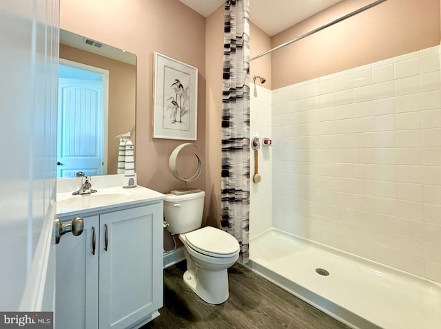 bathroom with toilet, vanity, a shower with curtain, and hardwood / wood-style floors