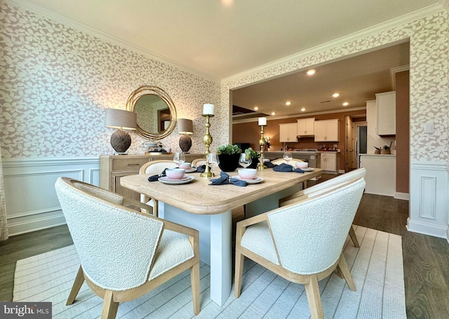 dining area with ornamental molding and dark hardwood / wood-style flooring