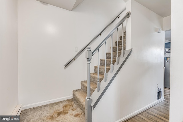 staircase with a baseboard radiator