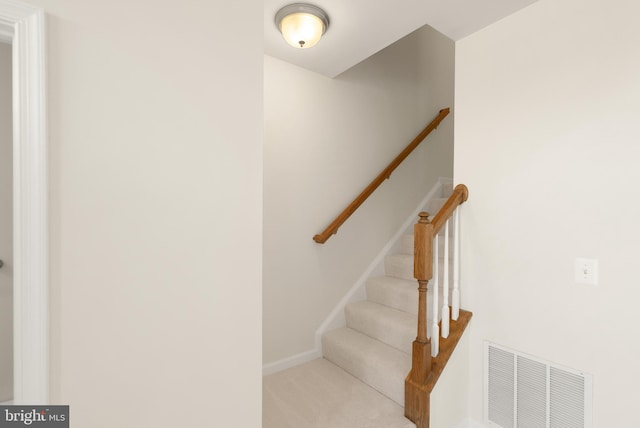 stairway featuring carpet flooring, visible vents, and baseboards