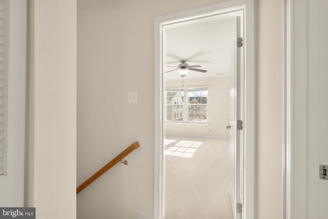 corridor featuring carpet and an upstairs landing