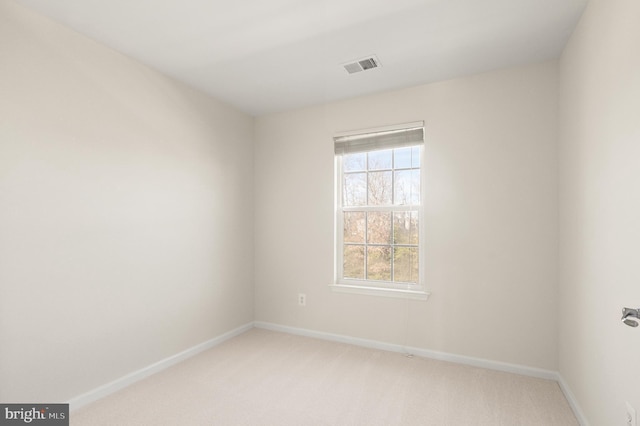 carpeted empty room with a wealth of natural light, visible vents, and baseboards