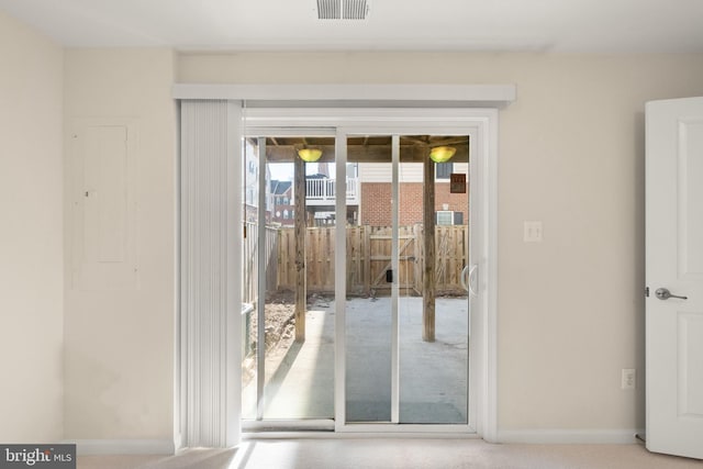 doorway to outside with visible vents and baseboards