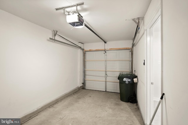 garage with baseboards and a garage door opener