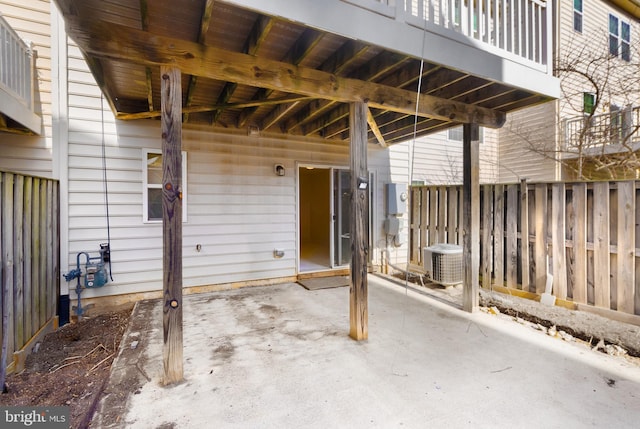 view of patio with fence and central AC unit