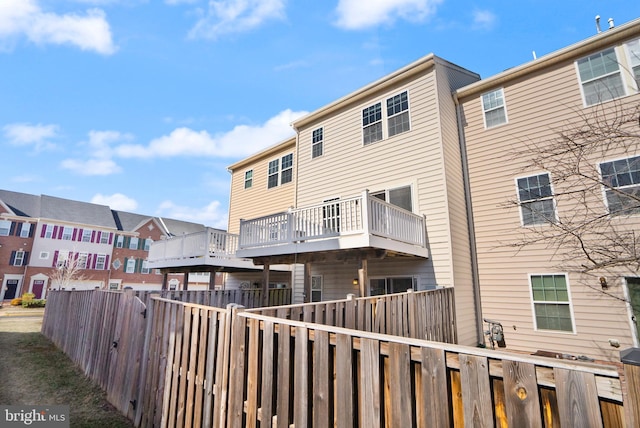 back of house featuring fence