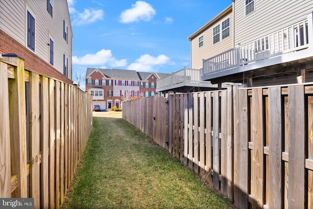 view of yard featuring fence and a residential view