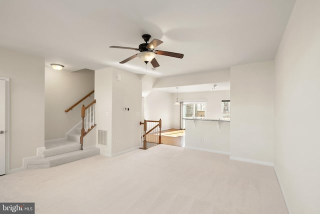 unfurnished room featuring light carpet, baseboards, and visible vents