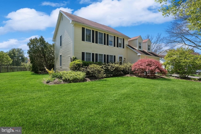 rear view of property with a yard