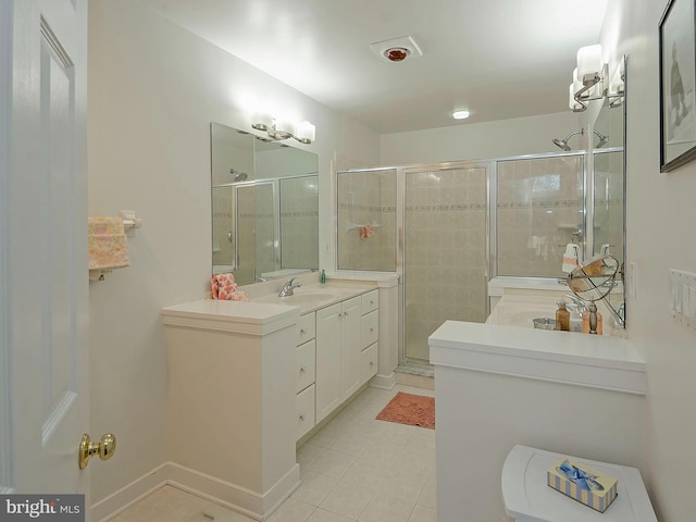 bathroom with tile patterned flooring, a shower with door, and vanity