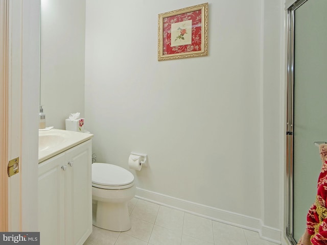 bathroom featuring toilet, tile patterned flooring, a shower with shower door, and vanity