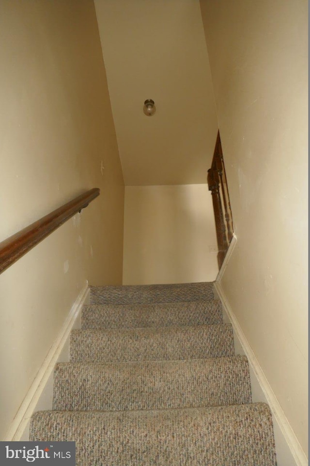 stairs with vaulted ceiling