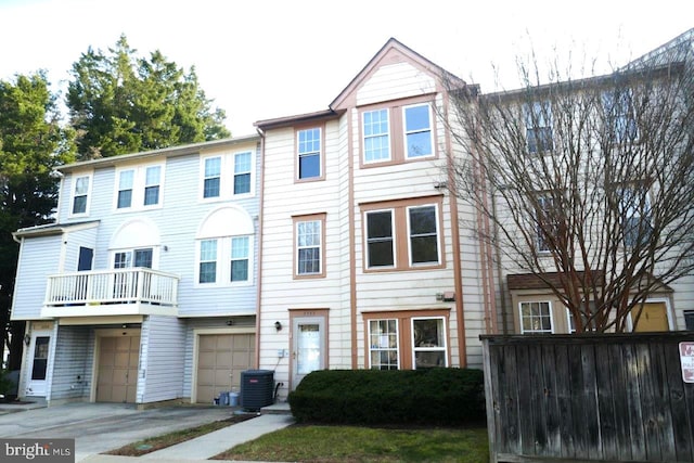 view of property featuring cooling unit and a garage