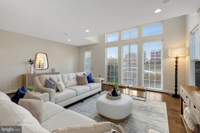 living room with plenty of natural light, baseboards, wood finished floors, and recessed lighting