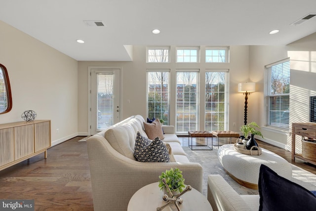 living area with a wealth of natural light, wood finished floors, and visible vents