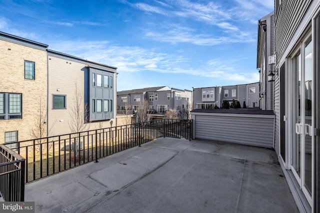 view of patio featuring a residential view and a balcony