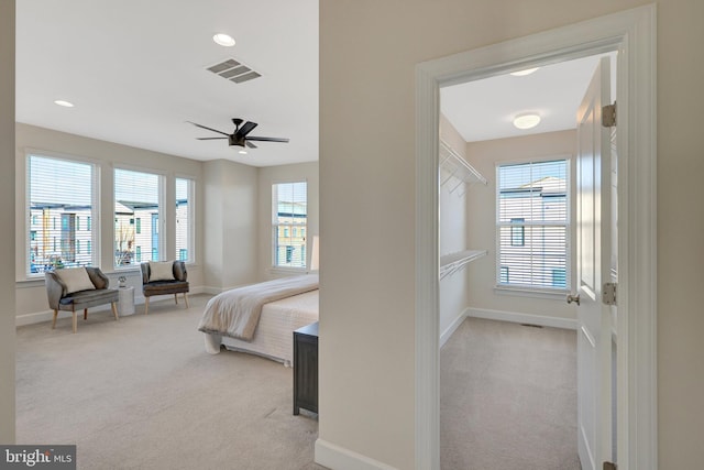 bedroom featuring light carpet, multiple windows, and visible vents