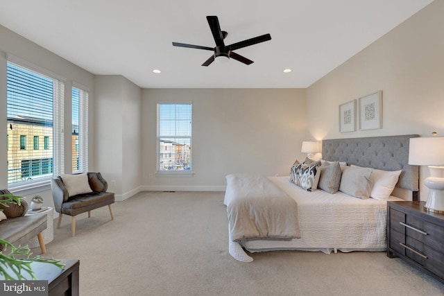 bedroom featuring a ceiling fan, recessed lighting, light colored carpet, and baseboards