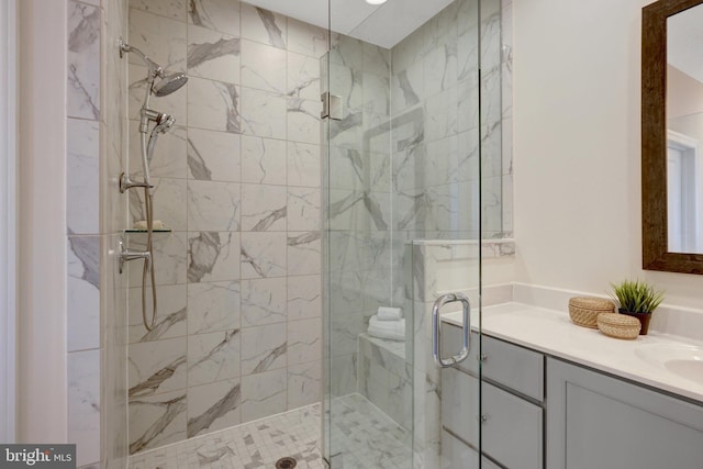 bathroom with a stall shower and vanity