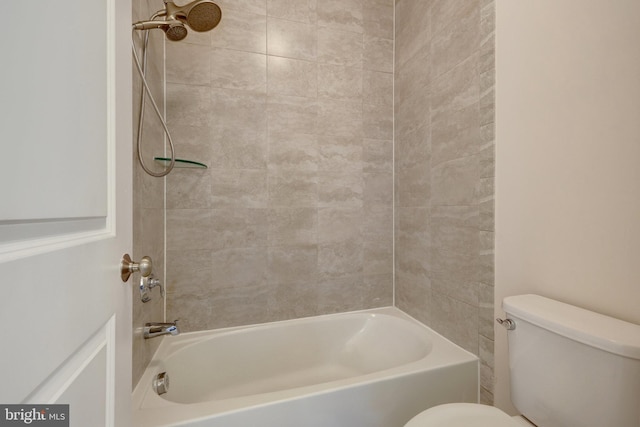 bathroom featuring bathtub / shower combination and toilet