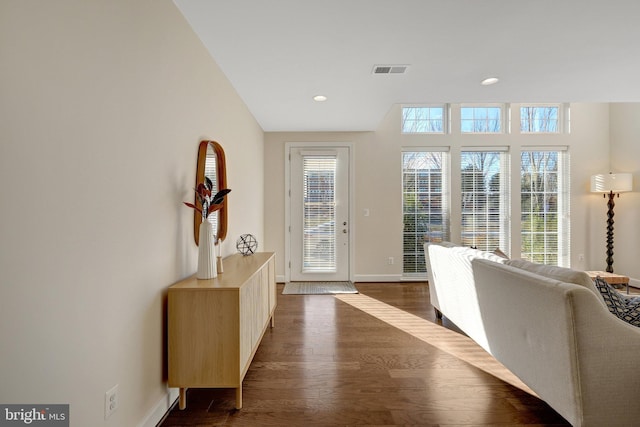 doorway featuring dark wood-style floors, recessed lighting, visible vents, and baseboards