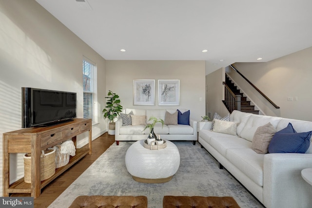 living area with stairs, recessed lighting, and wood finished floors