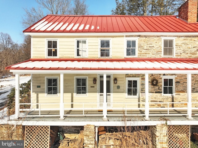 back of property with a porch