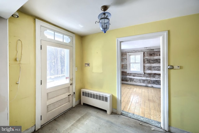 doorway with a wealth of natural light and radiator heating unit