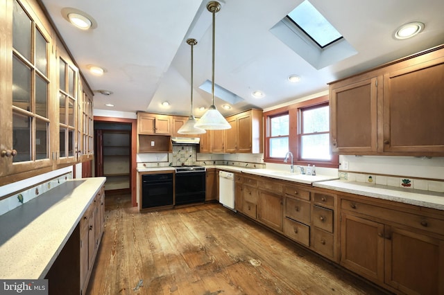 kitchen featuring decorative light fixtures, sink, stove, white dishwasher, and dark wood-type flooring