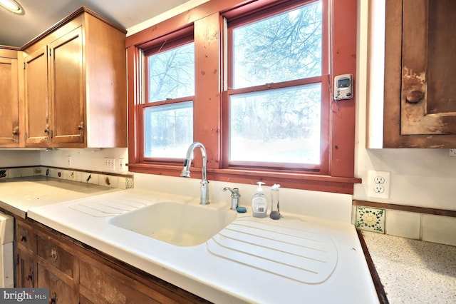 kitchen with plenty of natural light, sink, and dishwashing machine