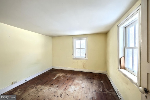 unfurnished room featuring dark hardwood / wood-style flooring