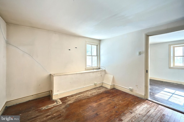 unfurnished room featuring dark wood-type flooring