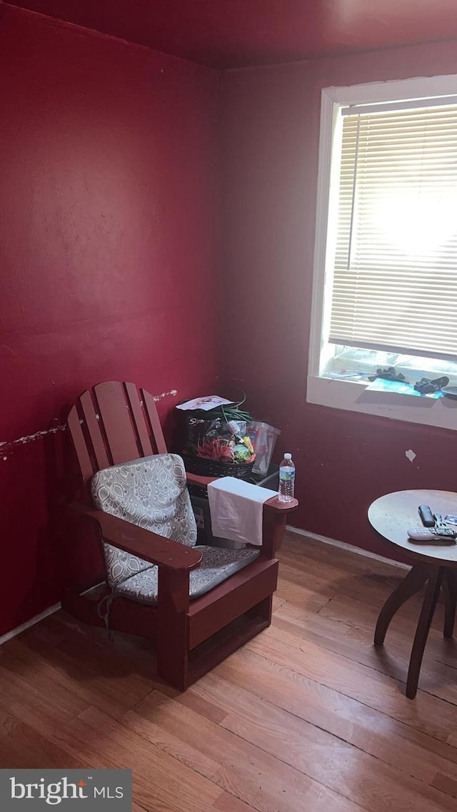 sitting room with hardwood / wood-style flooring